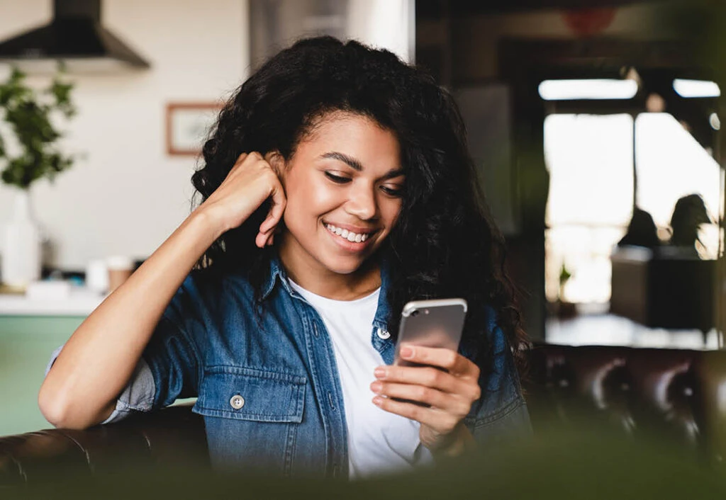 woman at home looking at phone
